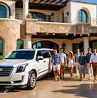 Group dropped off in front of a luxury Cabo villa by an Escalade SUV